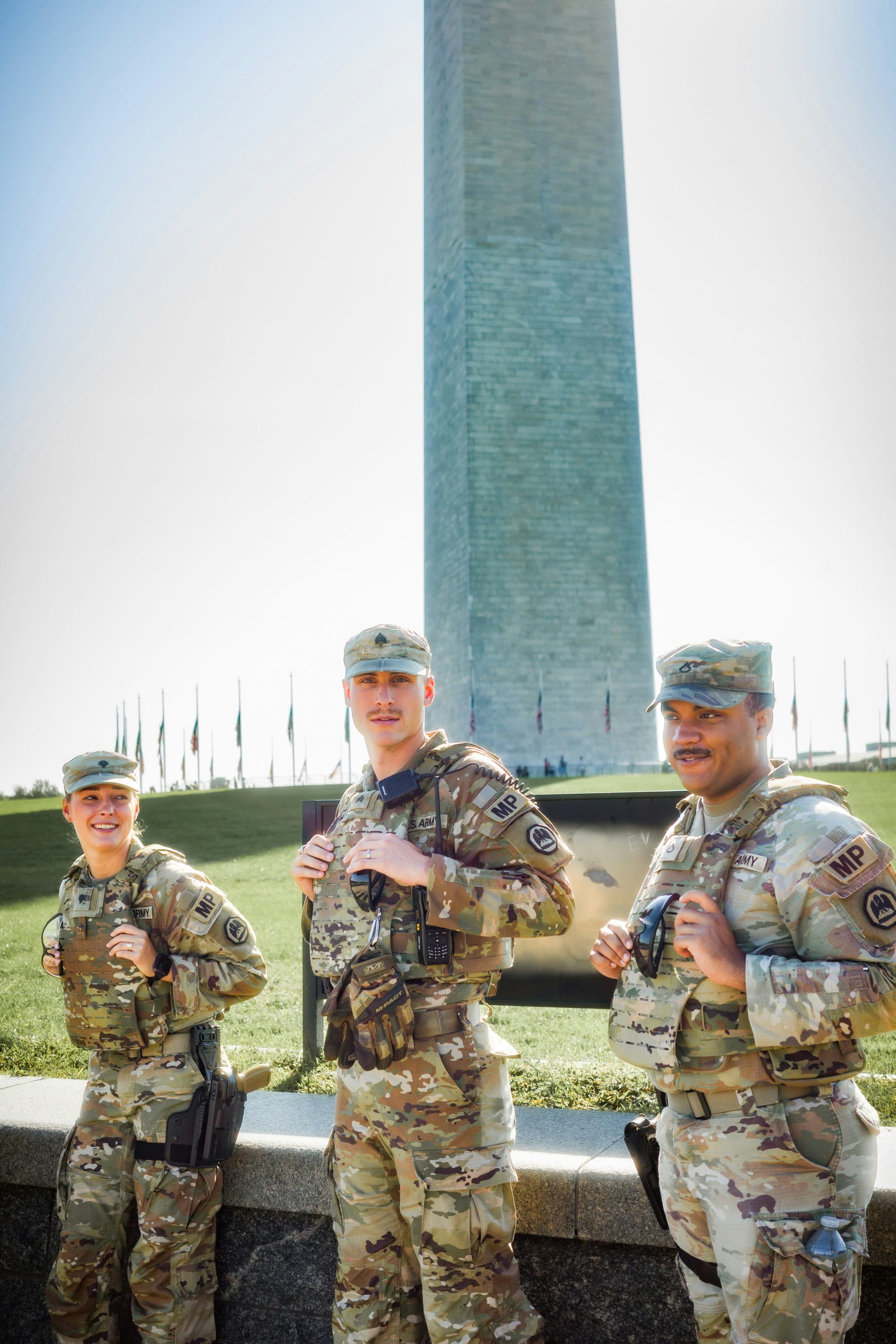 Three U.S. Army soldiers in uniform at the Washington Monument